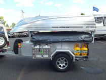 Camper trailer with boat on top