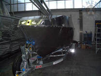 Dark-hulled boat on trailer
